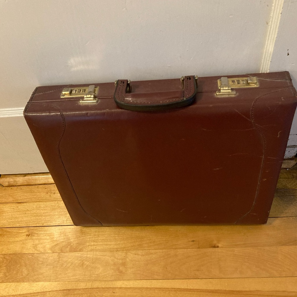 Men’s style briefcase with combo lock, some light scuffs.